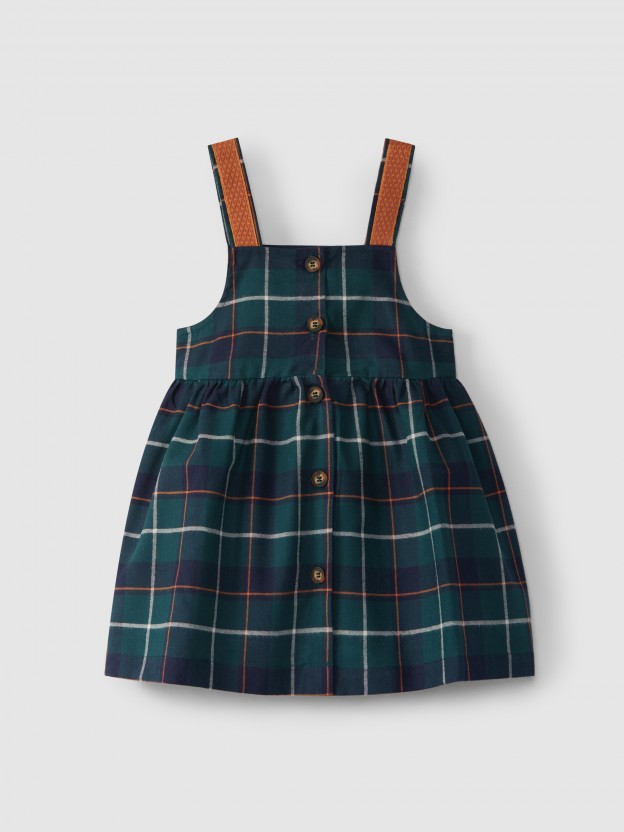 Plaid high-waisted skirt with suspenders.