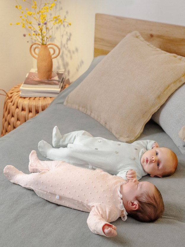 Babygrow embossed stripes with decorative buttons on the front Babygrow embossed stripes with decorative buttons on the front