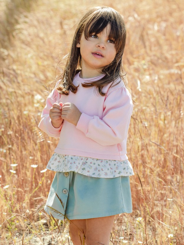 Plush sweater with ruffled detail in printed fabric
